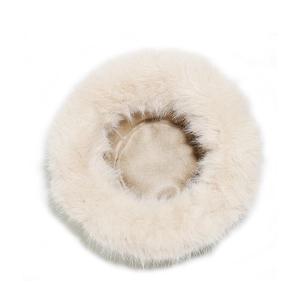 Top view detail of fluffy faux fur winter hat in creamy beige soft plush material
