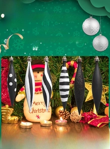 Detail of six long tapered Christmas tree ornaments with black and white patterns