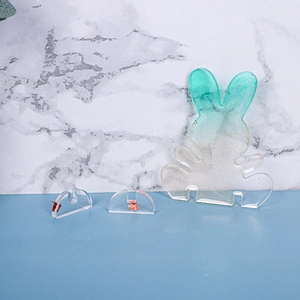 Detailed view of DIY resin rabbit mold parts with teal glitter and gold foil accents