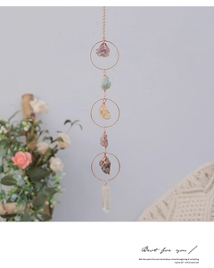 Detailed view of handmade suncatcher with natural raw crystals and amethyst pillar