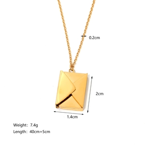 Close-up of gold envelope locket pendant showing dimensions and polished metal texture