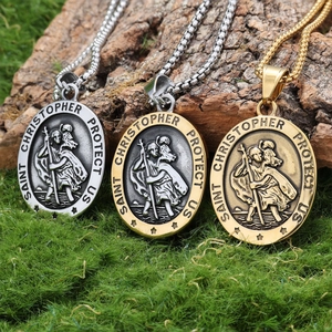 Viking Saint Christopher medal necklaces in silver and gold finishes on natural moss