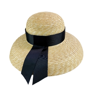 French style straw sun hat with black ribbon and streamers for summer beach travel