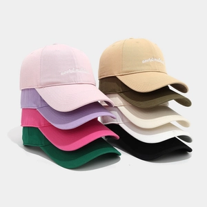 Multiple baseball caps with overstimulated embroidery in various colors on white background