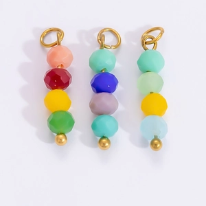 Close-up of colorful faceted bead pendants with golden rings for DIY jewelry making