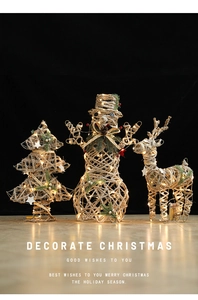 Detail of glowing iron snowman and reindeer ornaments with warm white LED lights