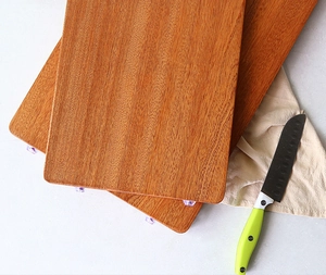 Detail view of rectangular ebony wood cutting boards with purple non-slip feet