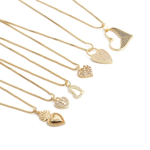 Gold heart pendant necklaces with cubic zirconia in various styles on white background