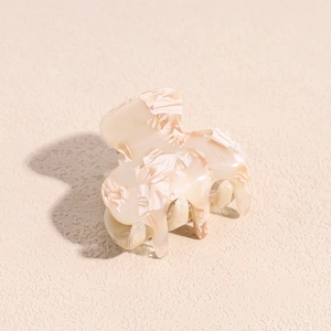 Detailed close-up showing the elegant marble texture on a milk white acetate hair claw clip