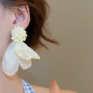 Detailed close-up of white chiffon flower earrings with beads for non-pierced ears