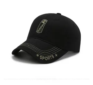 Detail of black baseball cap featuring gold embroidery and yellow contrast stitching
