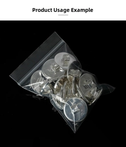 Macro shot of silver round metal DIY jewelry bases inside a clear thick PE self-sealing bag