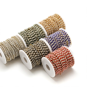 Macro view of rolls of pearl and colorful rhinestone chains for DIY jewelry making
