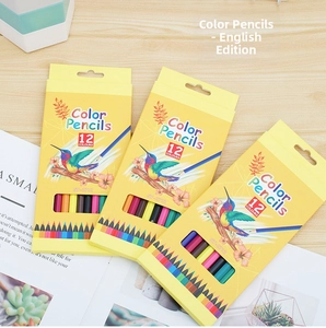 Set of 12 vibrant colored pencils in a yellow box with hummingbird art on a wood desk