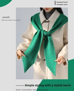 Detail of bright green chunky knit hood scarf on a beige coat for winter warmth