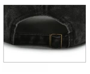 Detail of adjustable bronze metal buckle and washed denim strap on the vintage cap
