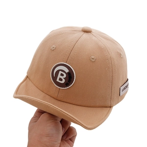 Minimalist beige baby baseball cap with letter B leather patch and curved brim