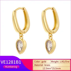 Elegant gold-tone teardrop earrings with white zircon pendant on a minimalist white base