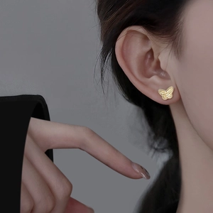 Golden butterfly stud earrings with honeycomb texture finish for a modern luxury look