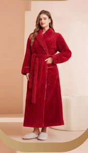 Thick red plush bathrobe detail with waist tie and soft coral fleece texture