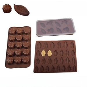 Silicone chocolate molds set with floral and leaf patterns and a storage lid