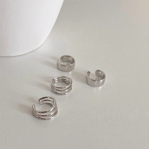 Detail shot of four-piece silver multi-layer ear cuff set with polished metallic finish