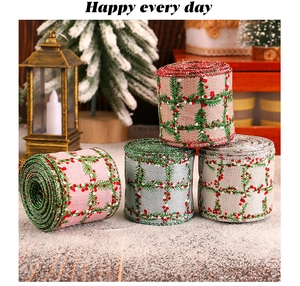 Detailed view of four plaid Christmas ribbons with pine branch and berry patterns