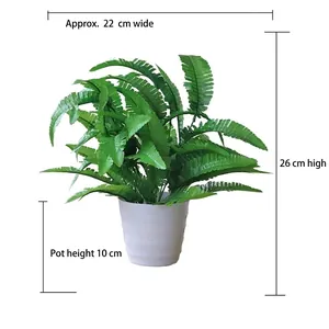 Artificial green fern plant in white textured pot, height 26cm and width 22cm