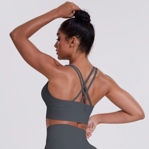 Detail of cross-back straps on dark gray sports bra with moisture-wicking fabric