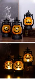 Detail of Halloween pumpkin lanterns with LED glowing effect and vintage lantern design