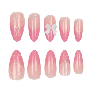 Pink gradient press-on nails with white 3D bows and pearls in elegant almond shape