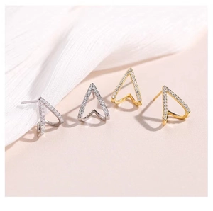 Detailed macro view of V-shaped geometric stud earrings with sparkling cubic zirconia stones