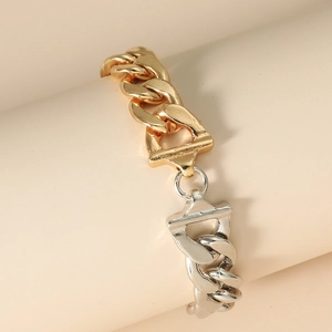 Detail of mixed-metal chunky chain bracelet with gold and silver links and buckle decor