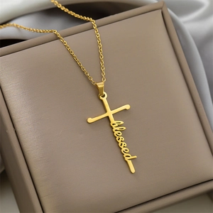 Close-up of golden stainless steel necklace with cursive blessed lettering and cross pendant