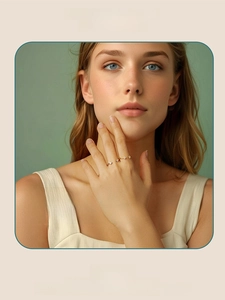 Moissanite ring in gold finish on model with elegant green studio background