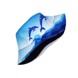 Detail showing dolphin print and stitching on the light blue ocean-themed sun hat