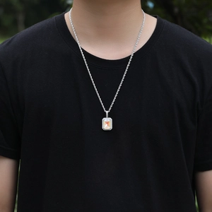 Detail van hiphop-hangerketting met iriserende oranje edelsteen op zilveren ketting