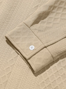 Macro shot of sleeve cuff detail with waffle texture fabric and a white button