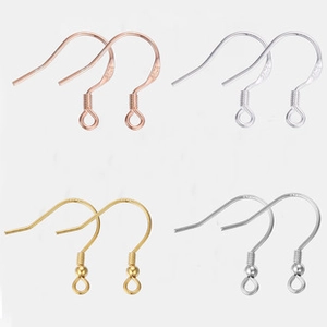 Macro detail of S925 sterling silver earring hooks in gold, rose gold, and silver finishes
