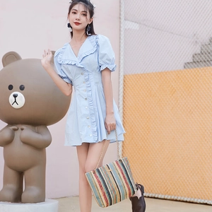 Summer light blue ruffled V-neck dress paired with a colorful striped woven bucket bag