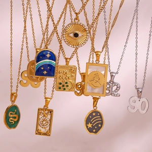 Close-up of 18K gold plated tarot and evil eye pendants with sparkling rhinestone details