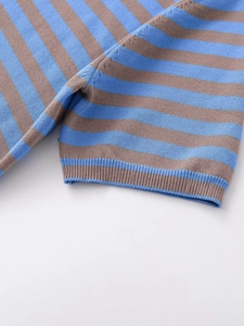 Detail of ribbed cuff and blue-brown striped knit fabric on a short sleeve top