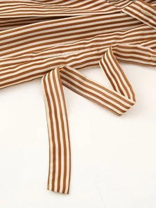 Detail of a brown and white striped tencel shirt dress with matching waist tie