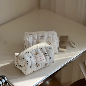 Detail of quilted cotton cosmetic bag featuring cute bear prints and zipper closure