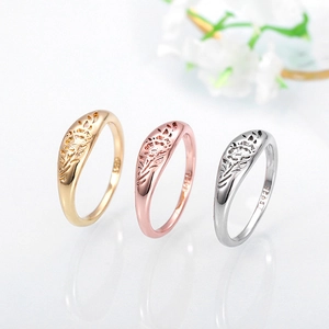 Macro shot of S925 hallmark on tri-color rings with intricate rose flower engravings