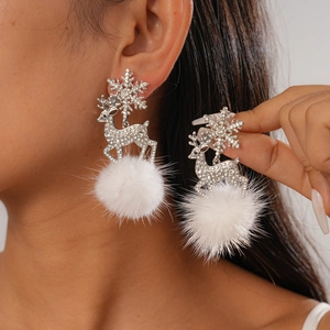 Detail of Christmas earrings featuring rhinestone snowflake, deer, and white plush balls
