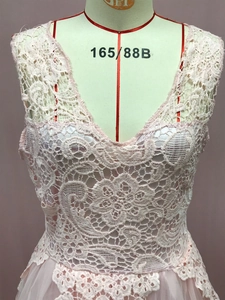 Close-up of floral lace bodice and layered mesh skirt on a pink sleeveless dress