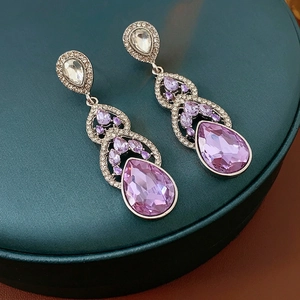 Elegant silver drop earrings featuring pear-cut purple crystals and zircon accents
