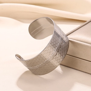 Detailed view of silver stainless steel cuff bangle with geometric triangle mesh pattern