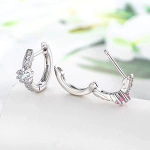 Star-inspired silver earrings with white and pink cubic zirconia in a modern hoop design